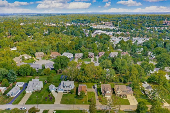 Aerial view of Cincinnati suburb residential homes with green yards and mature trees.