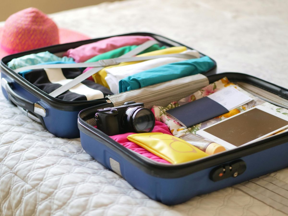 Packed suitcase with summer lake vacation gear and clothing, ready for a Norris Lake trip.