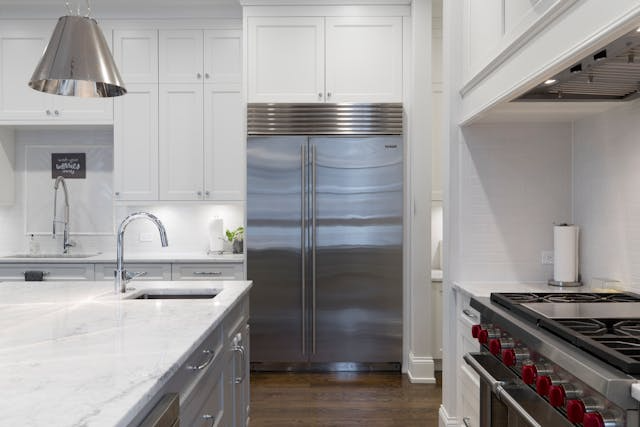 A renovated kitchen in a rental property with new countertops and appliances.